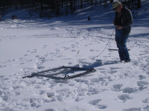 Metal detection with large frame coil on snow-covered ground