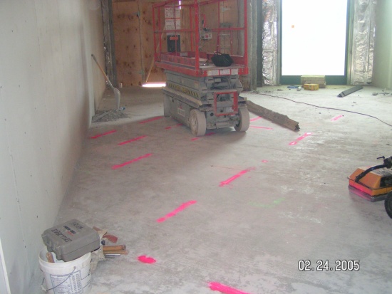 Concrete floor with pink paint marks showing post-tension tendon locations